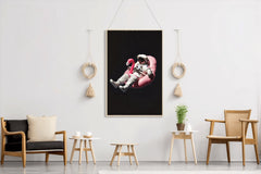 Spaceman floating free in space on a pink Inflatable Flamingo Ride-On - beink online art store